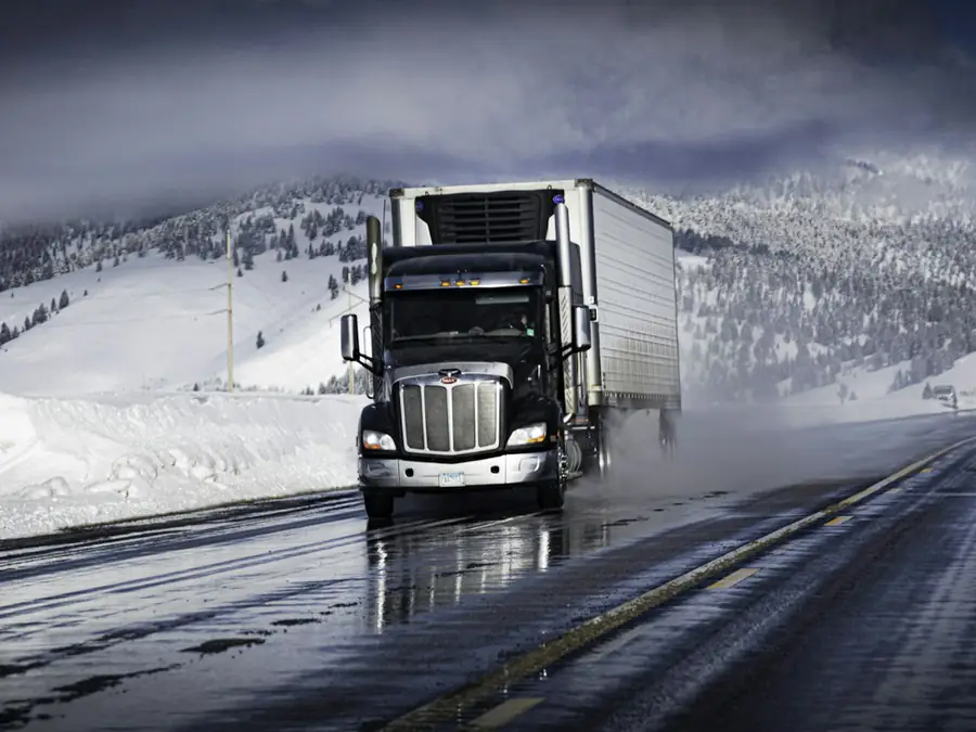 A transport truck running a wet winter highway